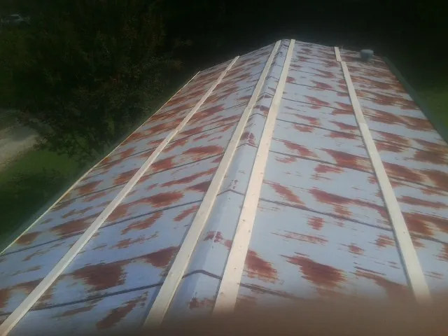 Rusted metal roof panels with new wood purlins before replacement — Storm Damage Roof Repair in Stevensburg by Roofing Brothers
