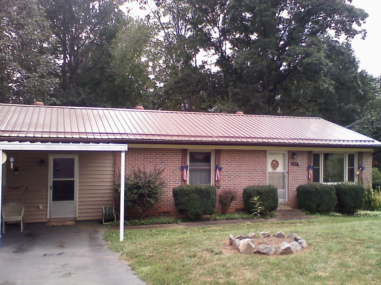 Bronze metal roof and carport on a brick ranch home — Roof Repair work by our crew in Stevensburg